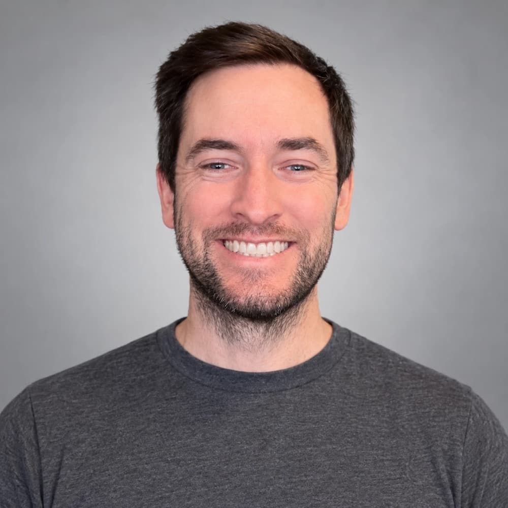 Jon Knack smiling in a studio portrait
